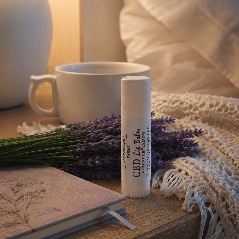 CPD lip balm standing on a table with lavender flowers behind