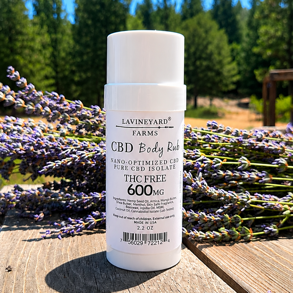 CBD body rub bottle with lavender flowers on a wooden surface