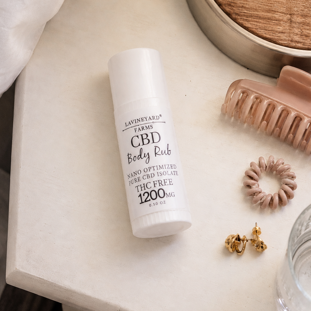 CBD body rub bottle on a surface with accessories