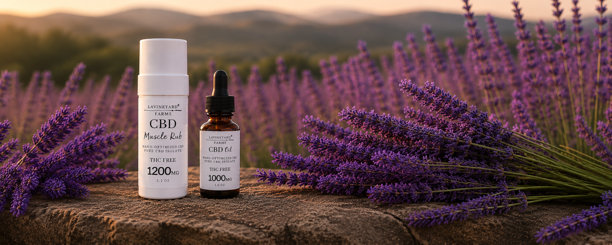 CBD products on a stone surface with lavender flowers and mountains in the background